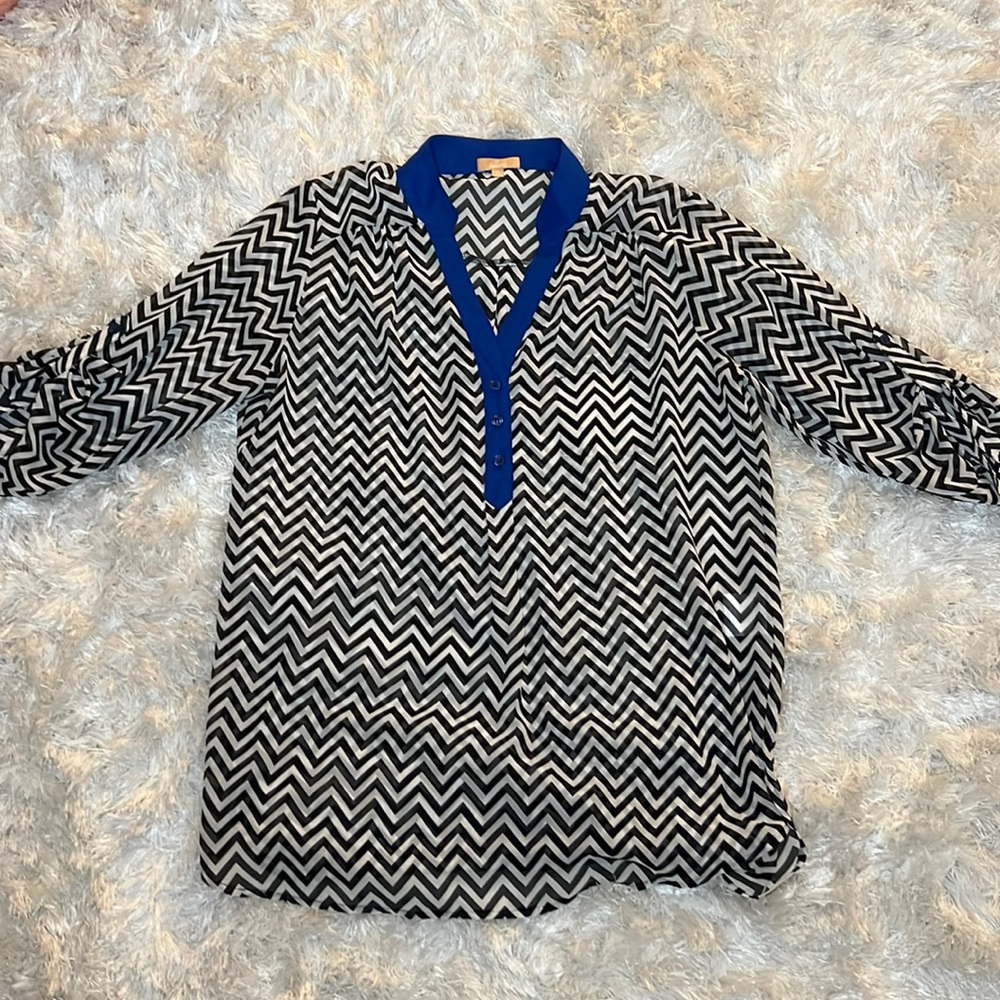 A X-large button up white and black striped Takara blouse.